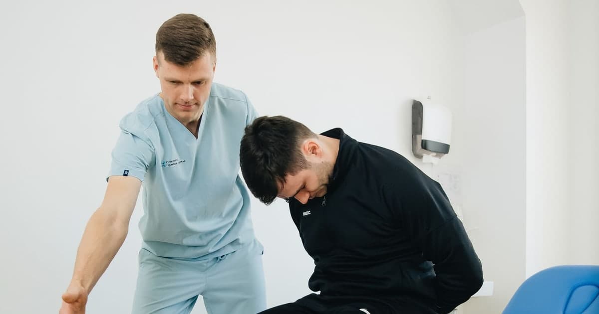 A physiotherapist assisting a person during a clinic appointment