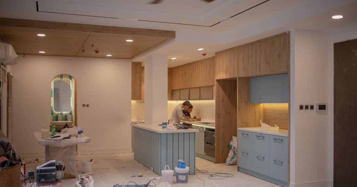 A worker and equipment inside a home undergoing renovation