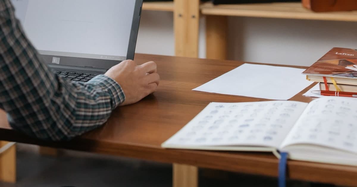 Shop owner reviewing a laptop behind a retail counter
